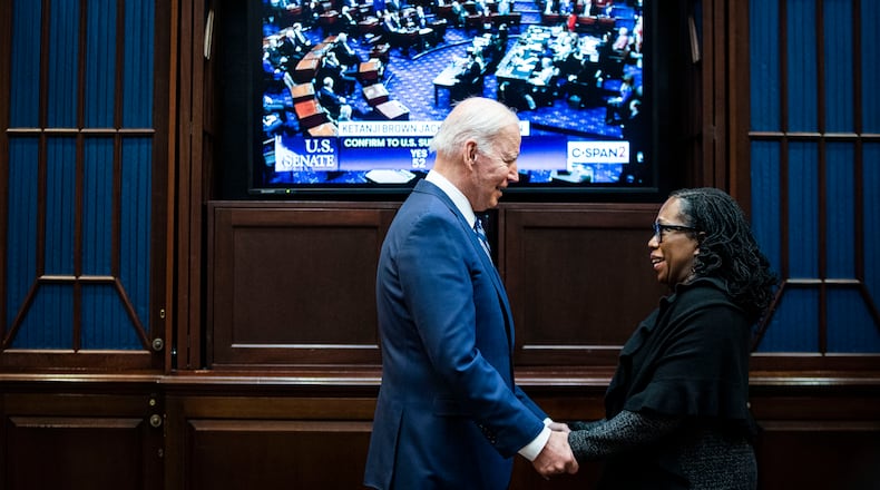 President Joe Biden and Judge Ketanji Brown Jackson watch as the Senate votes to confirm Jackson to the Supreme Court, from the Rosevelt Room of the White House in Washington on Thursday, April 7, 2022. (Al Drago/The New York Times)