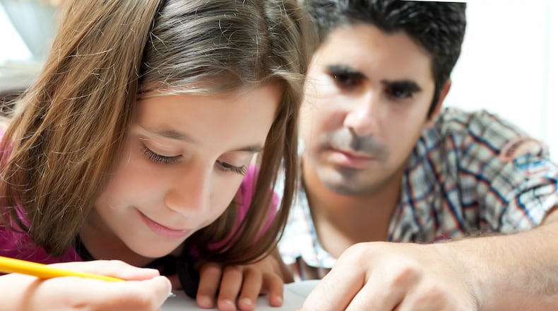 Today's middle-class parents spend more time with their kids, often around homework or school activities. Uncertain economic times may be one of the reasons.