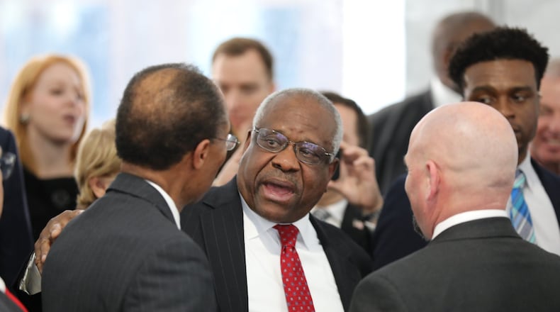 U.S. Supreme Court Justice Clarence Thomas talks with U.S. District Judge Steve Jones (left) after a ceremony on Tuesday, Feb. 11, 2020, in Atlanta. Thomas was the keynote speaker for the dedication of the Nathan Deal Judicial Center. (credit: Miguel Martinez for The Atlanta Journal-Constitution)