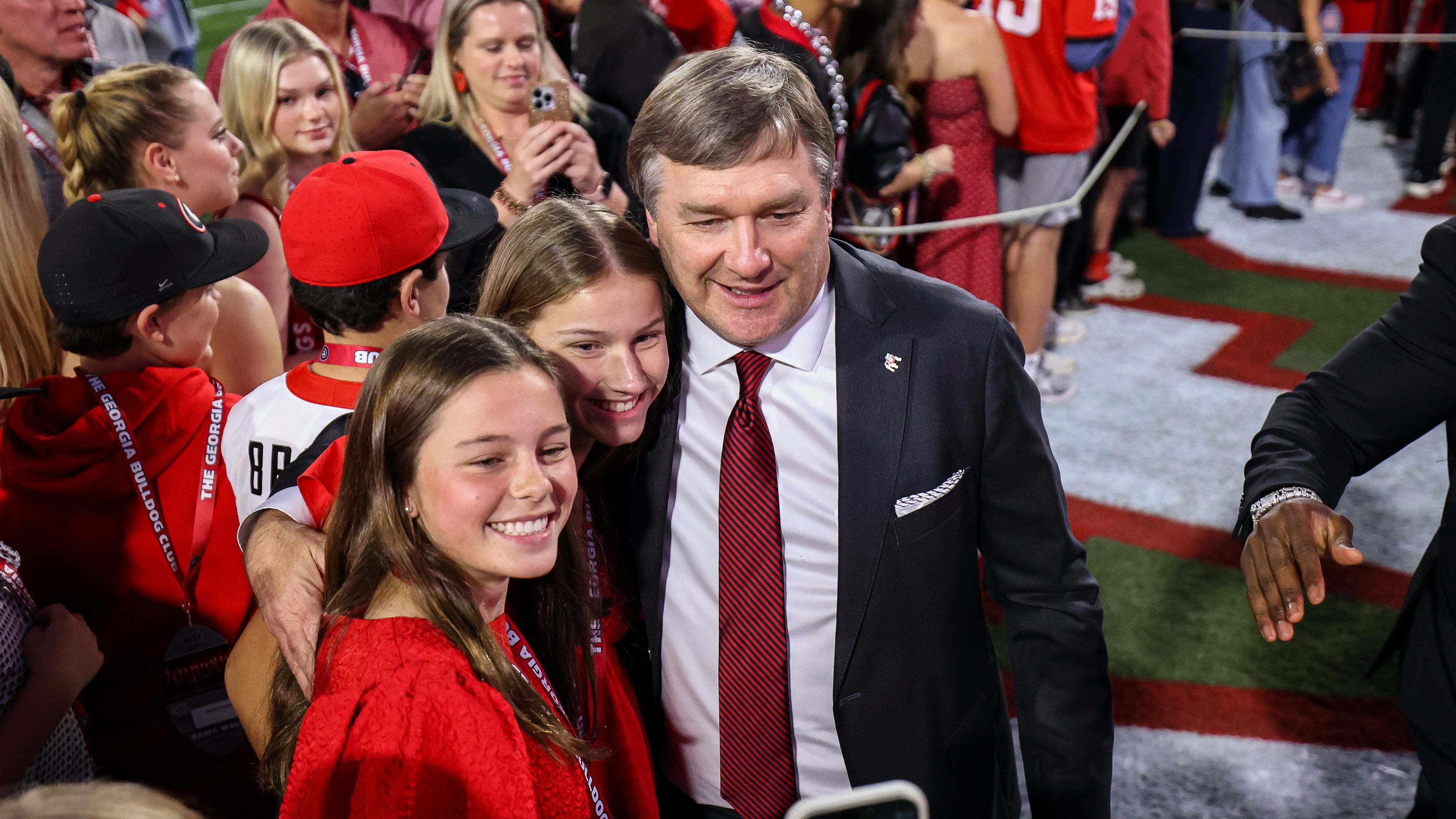 Georgia head coach Kirby Smart poses for a photo with fans before the start of an NCAA college football game against Texas, Saturday, Nov. 15, 2025, in Athens, Ga. (AP Photo/Colin Hubbard)