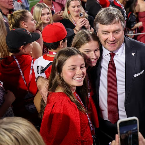 Georgia head coach Kirby Smart poses for a photo with fans before the start of an NCAA college football game against Texas, Saturday, Nov. 15, 2025, in Athens, Ga. (AP Photo/Colin Hubbard)