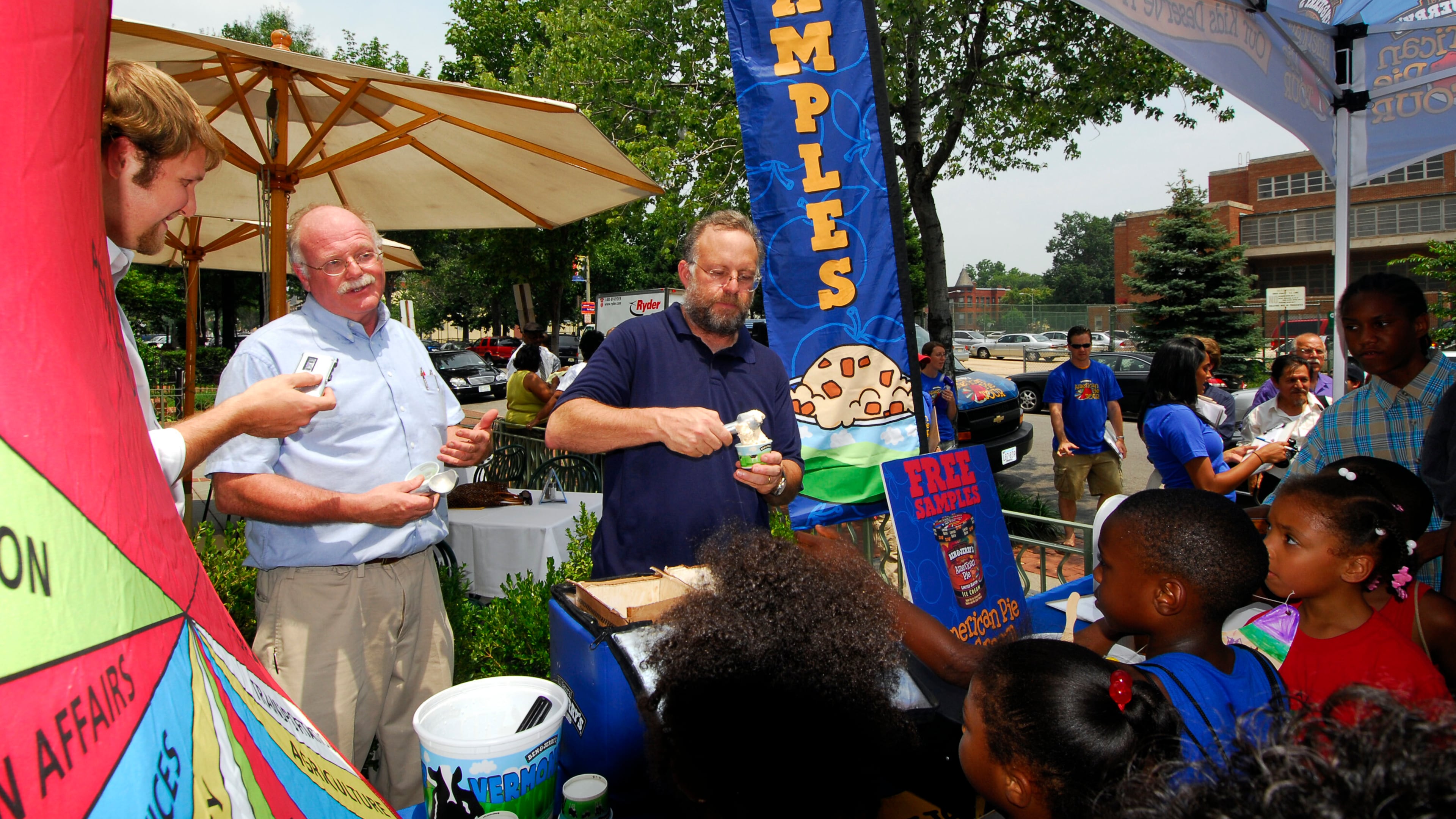 Ben Cohen, second from left, and Jerry Greenfield, center, founders of Ben & Jerry Homemade Inc., serve ice cream to Washington residents July 12, 2006, to kick off a federal budgets priority campaign. (AP Photo/Nick Wass)