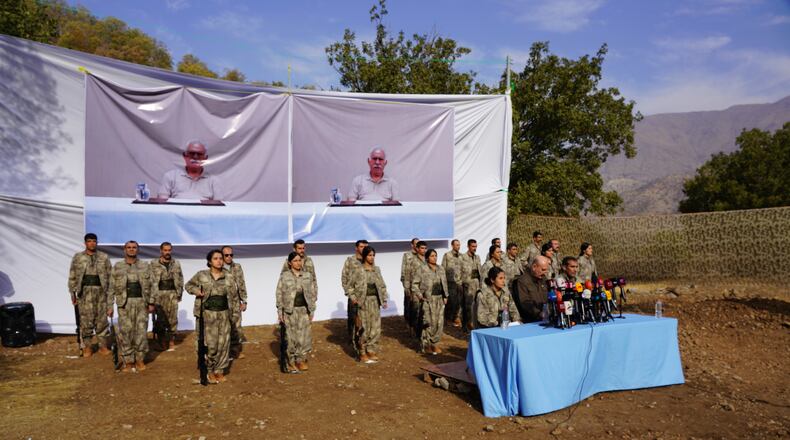 FILE - Kurdistan Workers' Party (PKK) fighters, who reportedly withdrew from Turkey with their weapons, stand to attention during a ceremony in the Qandil area of northern Iraq, щт Oct 26, 2025. (AP Photo/Rashid Yahya, File)