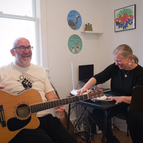 Paul and Melanie Shaw play music together in their Scottdale home. He's a guitarist and drummer. She plays theremin. They perform in the folk-inflected band Acoustic Station. (Courtesy of Dustin Timbrook)
