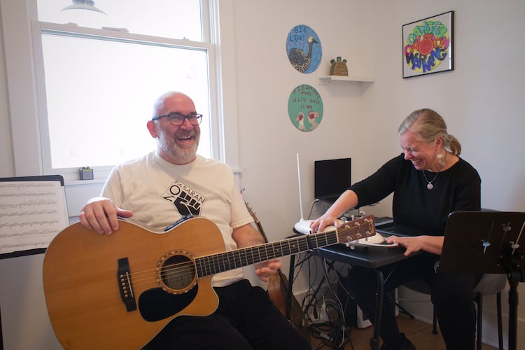 Paul and Melanie Shaw play music together in their Scottdale home. He's a guitarist and drummer. She plays theremin. They perform in the folk-inflected band Acoustic Station. (Courtesy of Dustin Timbrook)