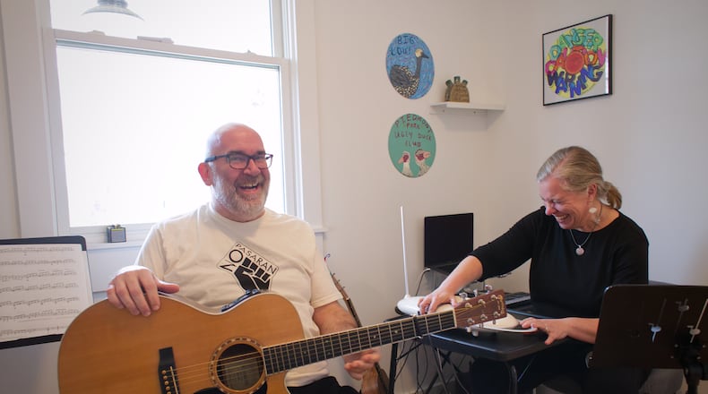 Paul and Melanie Shaw play music together in their Scottdale home. He's a guitarist and drummer. She plays theremin. They perform in the folk-inflected band Acoustic Station. (Courtesy of Dustin Timbrook)