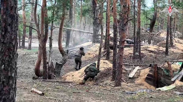 In this photo taken from video distributed by Russian Defense Ministry Press Service on Wednesday, May 21, 2025, Russian servicemen attend a combat training for assault units in an undisclosed location in Ukraine. (Russian Defense Ministry Press Service via AP)