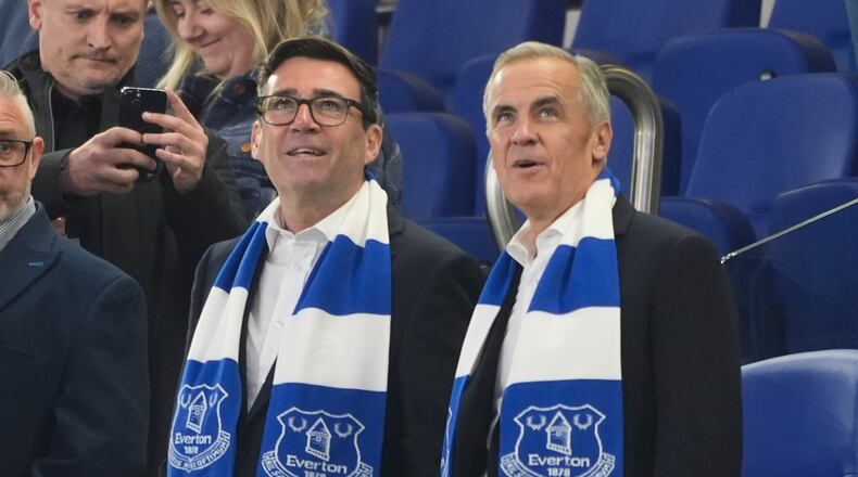 Britain's Prime Minister Andy Burnham, left, and Canada's Prime Minister Mark Carney attend the League Cup third round round soccer match between Everton and Wolverhampton Wanderers, Wednesday, Sept. 16, 2026, in Liverpool, England. (Peter Byrne/PA via AP)