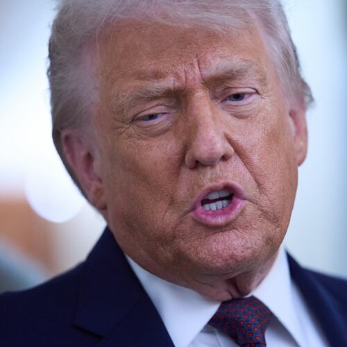 President Donald Trump speaks with reporters aboard Air Force One after leaving the World Economic Forum in Davos for Washington, Thursday, Jan. 22, 2026. (AP Photo/Evan Vucci)