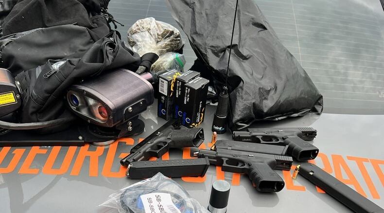 Three people suspected of stealing a car were taken into custody Friday after the car they're suspected of stealing was spotted at a Chick-fil-A drive-thru in East Point. Law enforcement officials released this photo of some of the contents reportedly found in the car.