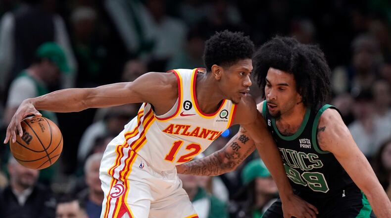 De'Andre Hunter drives against the defense of Celtics forward Justin Champagnie (99) during Sunday's game.