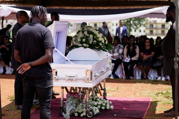 Mourners listen during the funeral service for Nigerian Ladi Anzaki Olubunmi, a TikTok content moderator employed by subcontractor Teleperformance, at the Langata cemetery in Nairobi, Kenya Thursday, April. 17, 2025. (AP Photo/Brian Inganga)