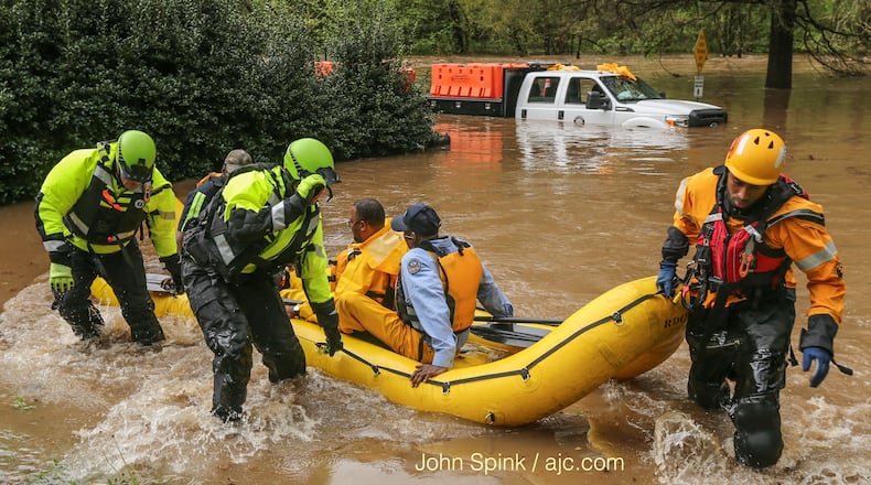 Atlanta watershed employees were rescued from the flooded Peachtree Creek near Woodward Way. JOHN SPINK/JSPINK@AJC.COM