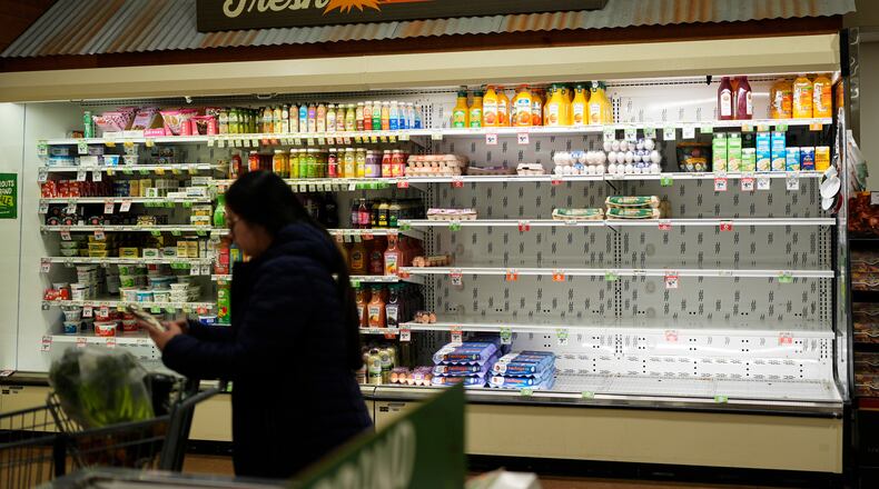 A shopper buys groceries Wednesday, Jan. 21, 2026, in Nashville, Tenn., ahead of a winter storm expected to hit the state over the weekend. (AP Photo/George Walker IV)