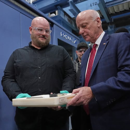 U.S. Treasurer Brandon Beach and Christopher Faulls hold some the last pennies to be pressed at the U.S. Mint in Philadelphia, Wednesday, Nov. 12, 2025. (AP Photo/Matt Slocum)