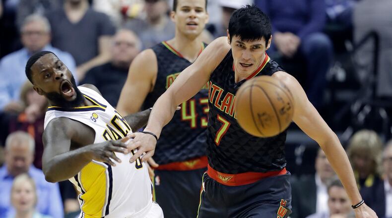 Indiana Pacers’ Lance Stephenson and Atlanta Hawks’ Ersan Ilyasova eye a loose ball during the first half of an NBA basketball game Wednesday, April 12, 2017, in Indianapolis. (AP Photo/Darron Cummings)