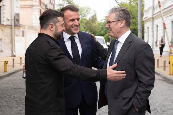 Ukrainian President Volodymyr Zelensky, left, Britain's Prime Minister Keir Starmer, right, and French President Emmanuel Macron, center, talk during a meeting in Kyiv, Ukraine, Saturday, May 10, 2025. (Stefan Rousseau/PA via AP, Pool)