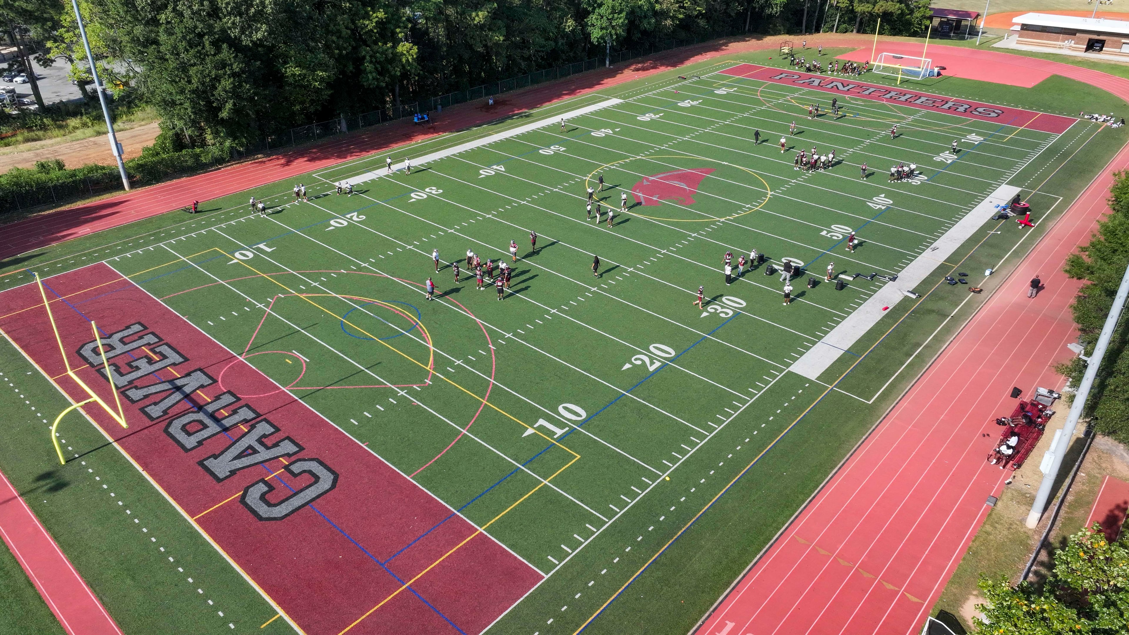 Carver High football players participate in a drill during their practice session Monday, Sept. 15, 2025. Darren Myles has been the team's coach for 20 years and is closing in on 150 wins. (Miguel Martinez/AJC)