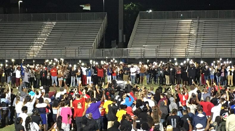 Mourners gather at the center of the Deerfield Beach (Fla.) High football stadium for a candelight vigil in memory of star football player Bryce Gowdy, who was to begin classes at Georgia Tech this Monday. (AJC photo by Ken Sugiura)