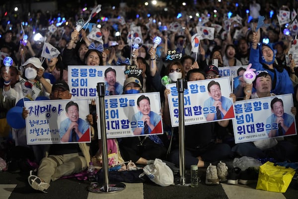 Supporters of South Korea's Democratic Party's presidential candidate Lee Jae-myung, react outside the National Assembly in Seoul, South Korea, Tuesday, June 3, 2025. (AP Photo/Ahn Young-joon)