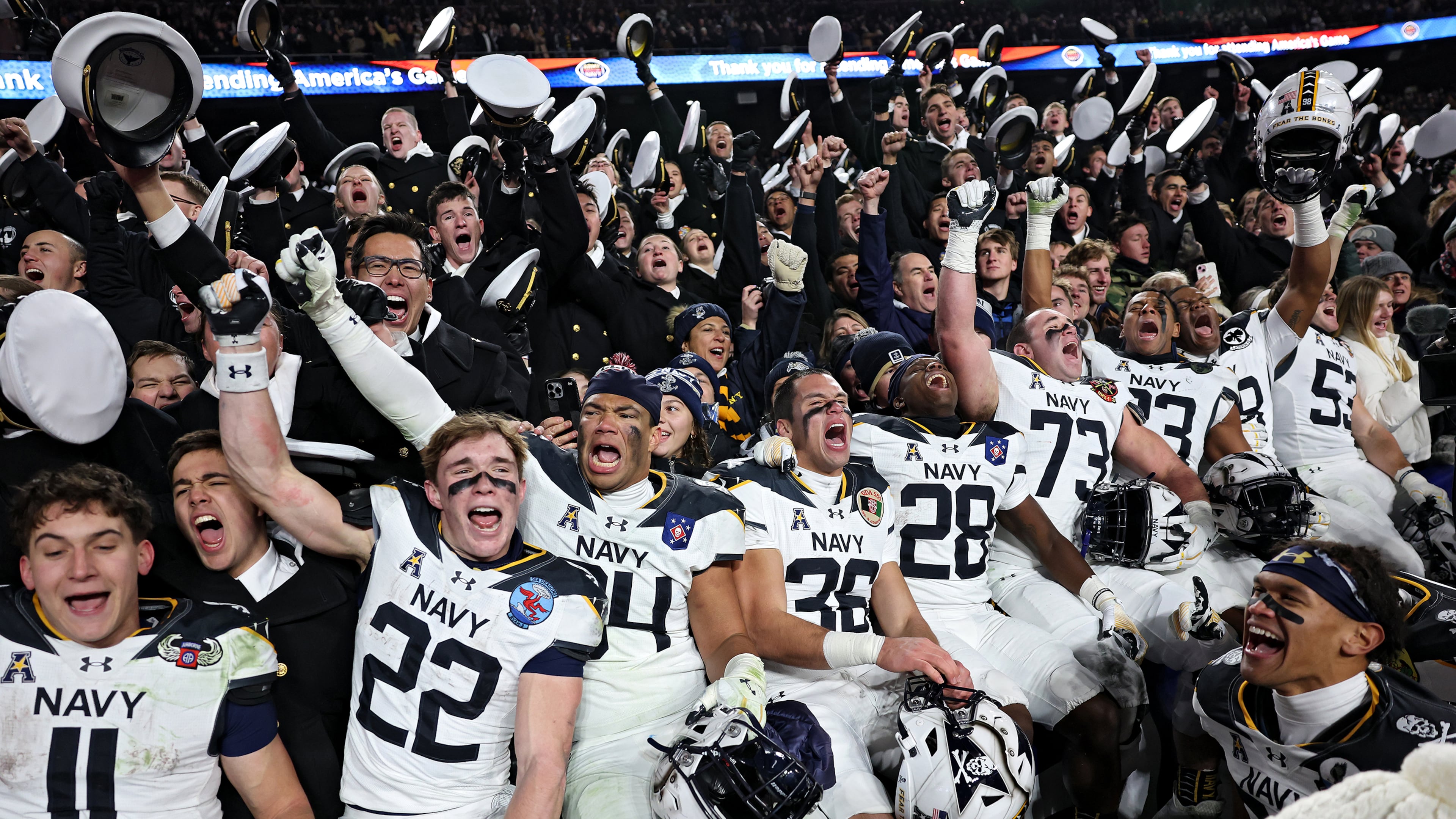 The Navy Midshipmen celebrate after defeating Army 31-13 during the 125th America’s Game at Northwest Stadium on Saturday, Dec. 14, 2024, in Landover, Md. It is a bitter and hard-fought rivalry, but one marked by respect, Ken Sugiura writes. (Patrick Smith/Getty Images/TNS 2024)