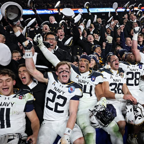 The Navy Midshipmen celebrate after defeating Army 31-13 during the 125th America’s Game at Northwest Stadium on Saturday, Dec. 14, 2024, in Landover, Md. It is a bitter and hard-fought rivalry, but one marked by respect, Ken Sugiura writes. (Patrick Smith/Getty Images/TNS 2024)