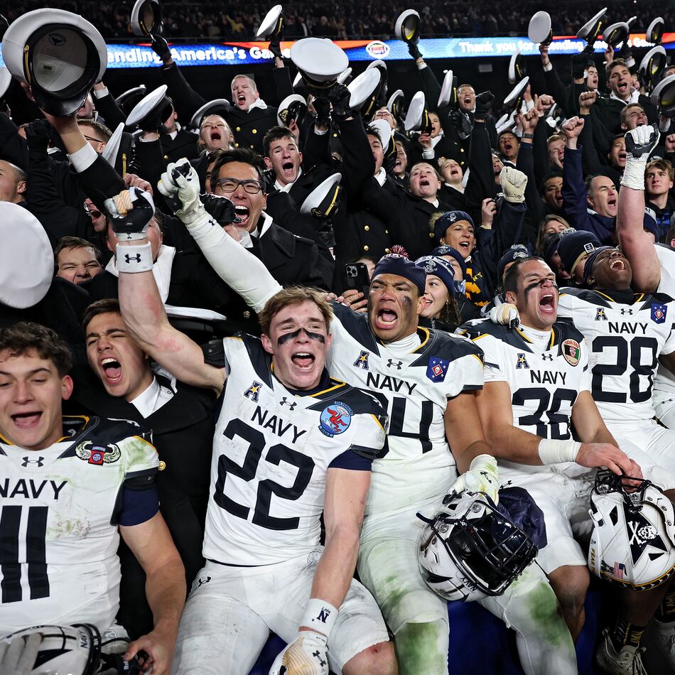 The Navy Midshipmen celebrate after defeating Army 31-13 during the 125th America’s Game at Northwest Stadium on Saturday, Dec. 14, 2024, in Landover, Md. It is a bitter and hard-fought rivalry, but one marked by respect, Ken Sugiura writes. (Patrick Smith/Getty Images/TNS 2024)