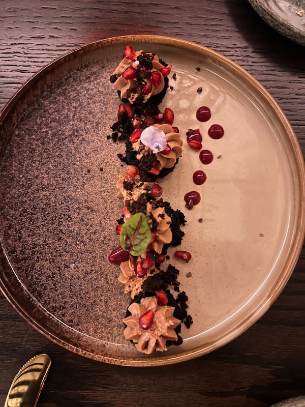 The Araguani chocolate with passion fruit ganache, pomegranate and mole crunch  is one of the plated desserts on the menu at Bar Ana. (Mike Jordan/AJC)
