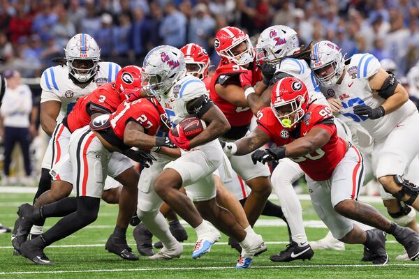 Ole Miss running back Kewan Lacy (front) breaks away from Georgia defensive lineman Elijah Griffin (right) during the Sugar Bowl at the Caesars Superdome on Thursday, Jan. 1, 2026, in New Orleans. Georgia lost to Ole Miss, 39-34, to conclude its 2025-26 season. (Jason Getz/AJC)