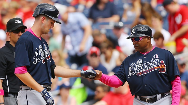 Braves pitcher Alex Wood gets a fist pump from first base coach Terry Pendleton after hitting his third single in the game against the Nationals during a baseball game on Sunday, May 10, 2015, at Nationals Park in Washington, D.C. Curtis Compton / ccompton@ajc.com