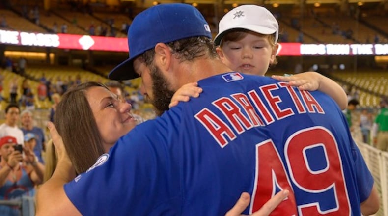 Chicago Cubs starting pitcher Jake Arrieta is congratulated by his wife Brittany and son Cooper after completing a no-hitter in a baseball game against the Los Angeles Dodgers, Sunday, Aug. 30, 2015, in Los Angeles. (AP Photo/Mark J. Terrill)