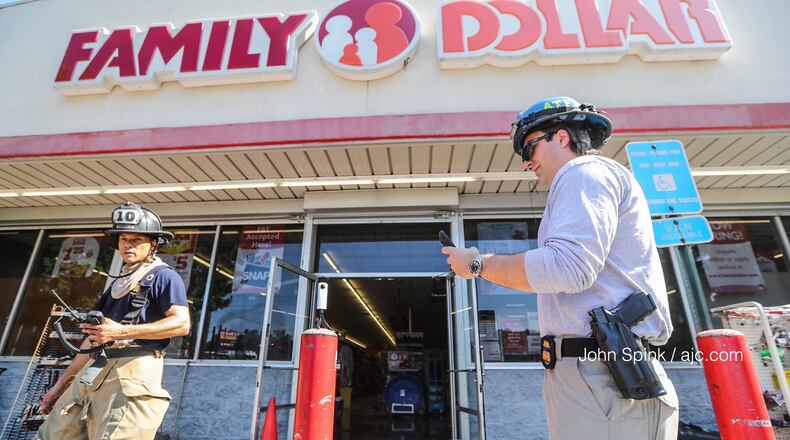 Four people were being treated for smoke inhalation after a fire at a Family Dollar on Glenwood Road and Columbia Drive.