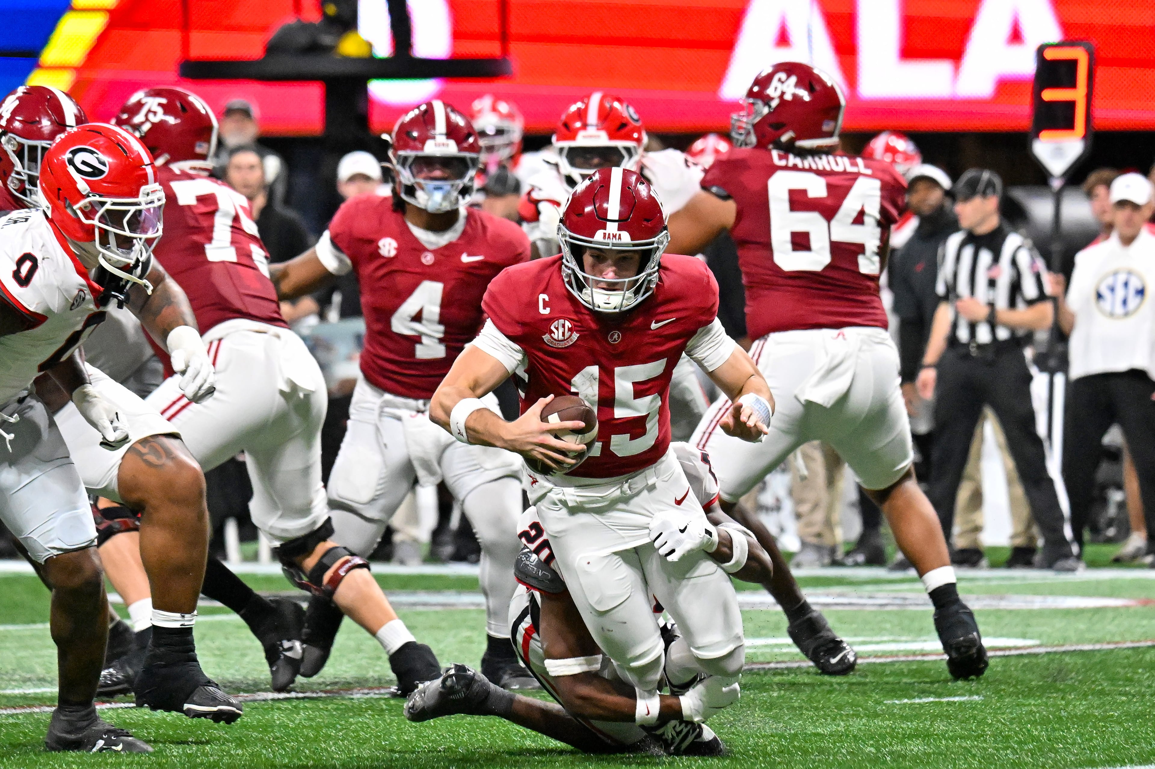 Alabama quarterback Ty Simpson (15) is sacked by Georgia defensive back Jacorey Thomas (20) during the third quarter of the SEC Championship game at Mercedes-Benz Stadium, Saturday, Dec. 6, 2025, in Atlanta. (Hyosub Shin / AJC)