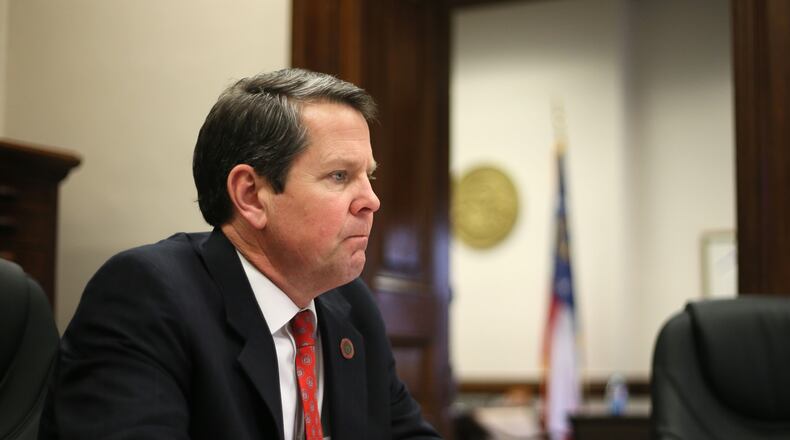Brian Kemp in a staff meeting at his office in the Capitol.