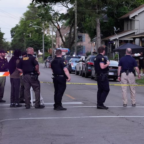Police stand near where multiple people were shot at a community festival Saturday, June 6, 2026, in Toledo, Ohio. (AP Photo/Paul Sancya)