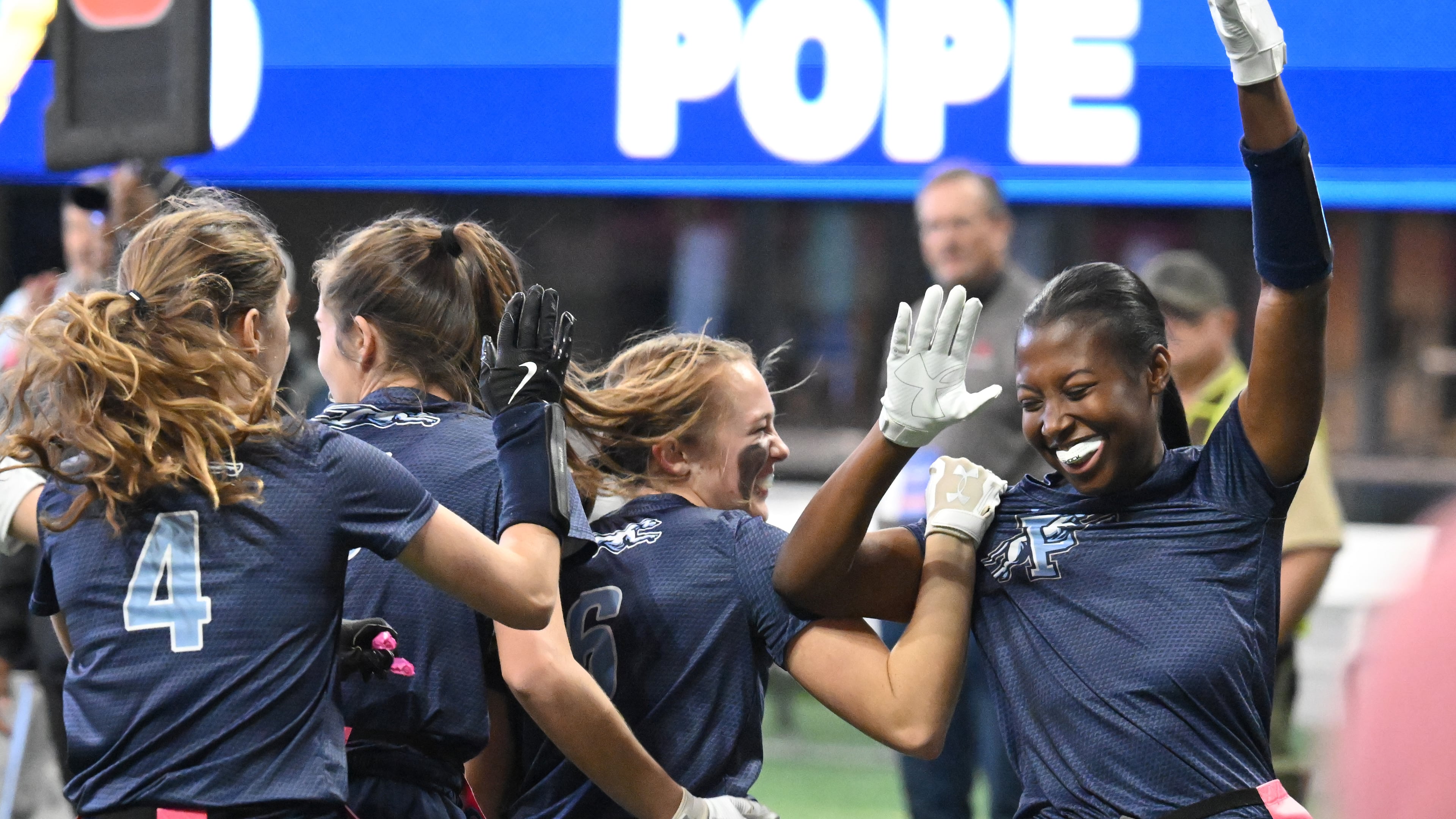 Pope’s Julia Acker celebrates with teammates in December. Pope won four state titles in 2024-25, tied with seven other schools for the most in the GHSA. (Hyosub Shin / AJC)