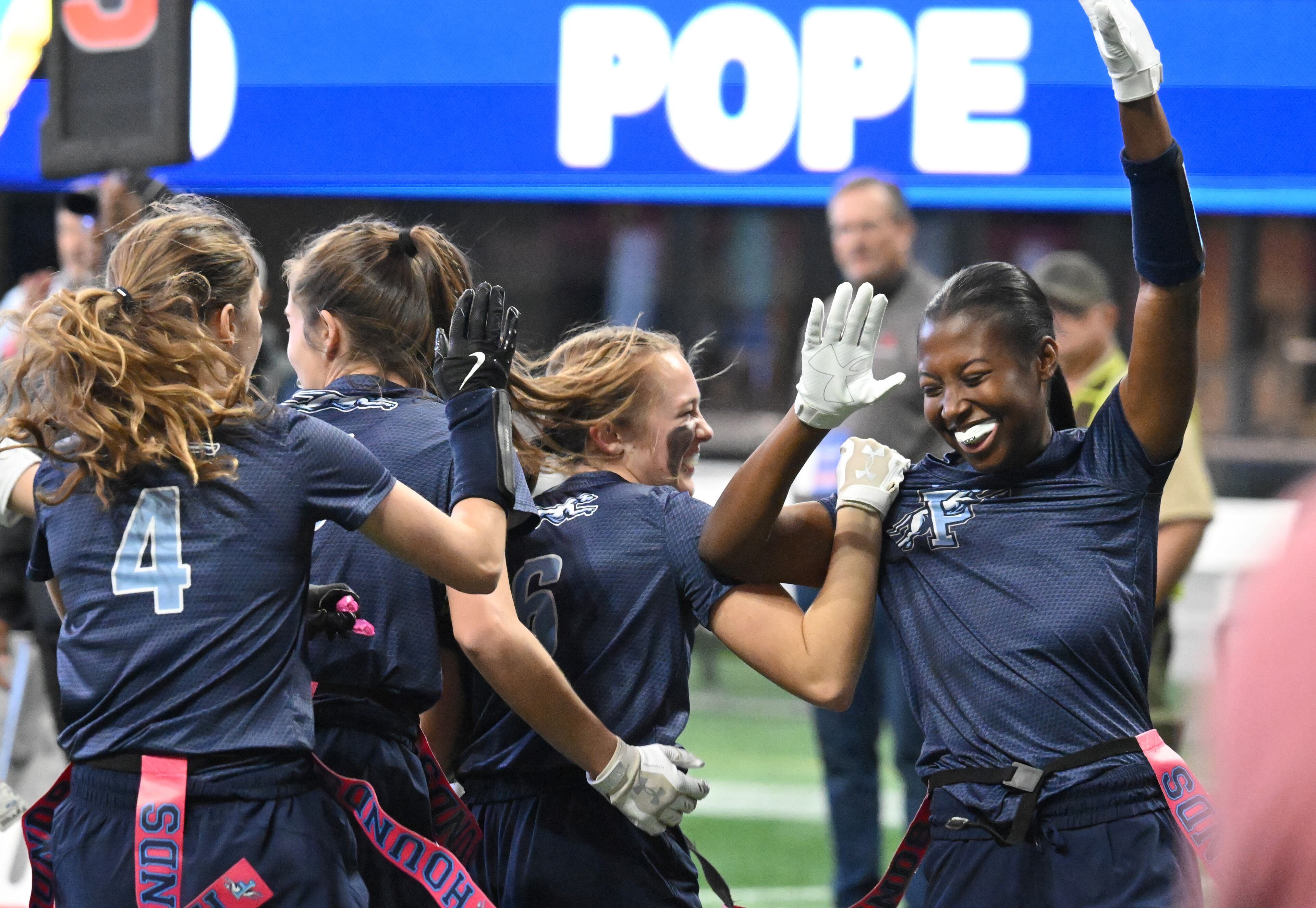 Pope’s Julia Acker celebrates with teammates in December. Pope won four state titles in 2024-25, tied with seven other schools for the most in the GHSA. (Hyosub Shin / AJC)