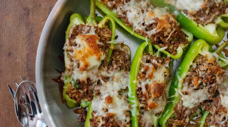 Halved Cubanelle peppers stuffed with beef, rice and topped with cheese make for a quick, filling meal.
(Virginia Willis for The Atlanta Journal-Constitution)