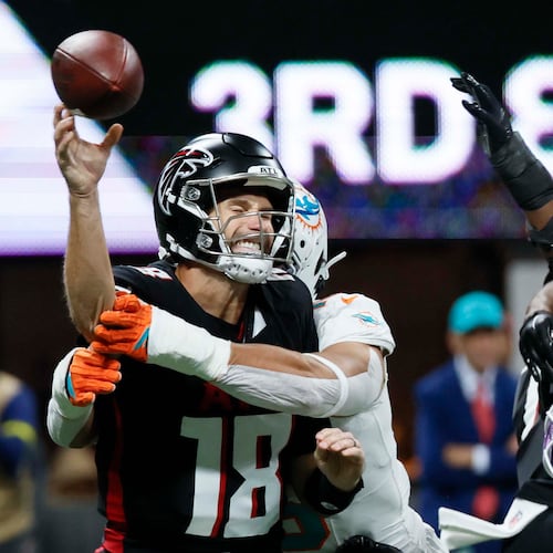 Atlanta Falcons quarterback Kirk Cousins (18) reacts after being sacked by Miami Dolphins linebacker Jaelan Phillips (15) during the first half of an NFL game at Mercedes-Benz Stadium in Atlanta on Sunday, October 26, 2025. 
(Miguel Martinez/ AJC)