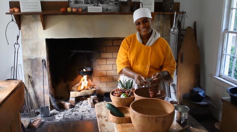 Living history interpreter and open-hearth cooking expert Clarissa Clifton preps fresh produce in the Cook House at the Archibald Smith Plantation in Roswell. When available she uses herbs and vegetables from the Smith garden.