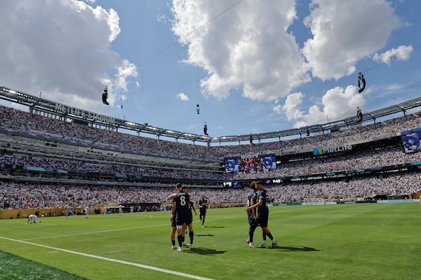 Paris Saint-Germain's Fabian Ruiz celebrates with team mates after scoring his side's third goal during the Club World Cup semifinal soccer match between PSG and Real Madrid in East Rutherford, N.J., Wednesday, July 9, 2025. (AP Photo/Adam Hunger)