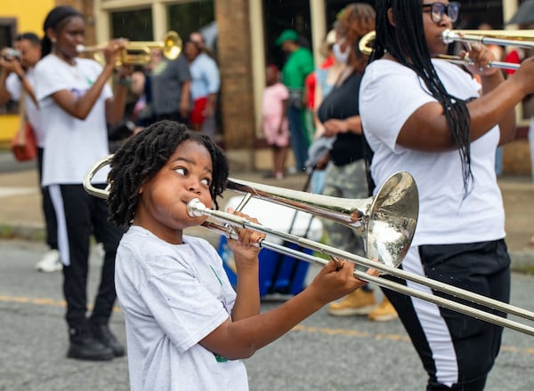 King Washington performs Saturday as the Juneteenth Atlanta parade makes its way along Monroe Drive to Piedmont Park. (Jenni Girtman for the AJC)