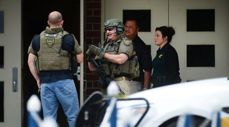 Marion County Police officers walk out a high school after a shooting there on April 20, 2018. In Georgia, Laurens County now plans to becomethe state’s first school district to authorize some teachers and others to carry guns on campus in hopes of preventing such incidents. (Photo by Gerardo Mora/Getty Images)