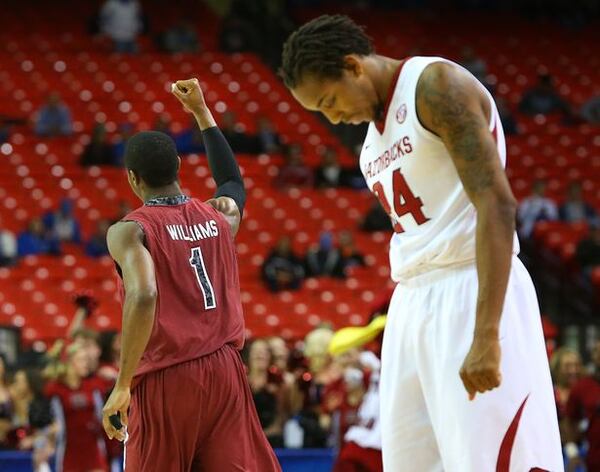 Arkansas' Michael Qualls looks down -- and probably out of the NCAA. (Curtis Compton/AJC)