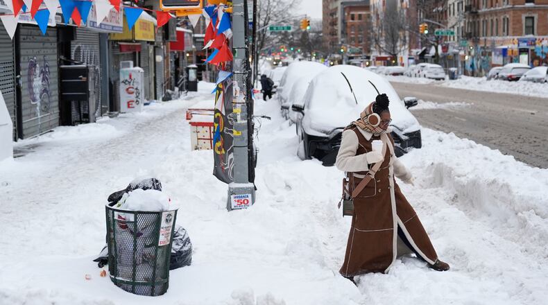 FILE - Carrie Hampton tries to navigate a snowy intersection without spilling her coffee in New York, Jan. 26, 2026. (AP Photo/Seth Wenig, File)