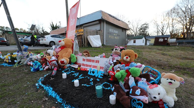 A memorial for 6-month-old Grayson Fleming-Gray is seen outside the Food Mart where he was killed last week in a drive-by shooting. (Curtis Compton / Curtis.Compton@ajc.com)