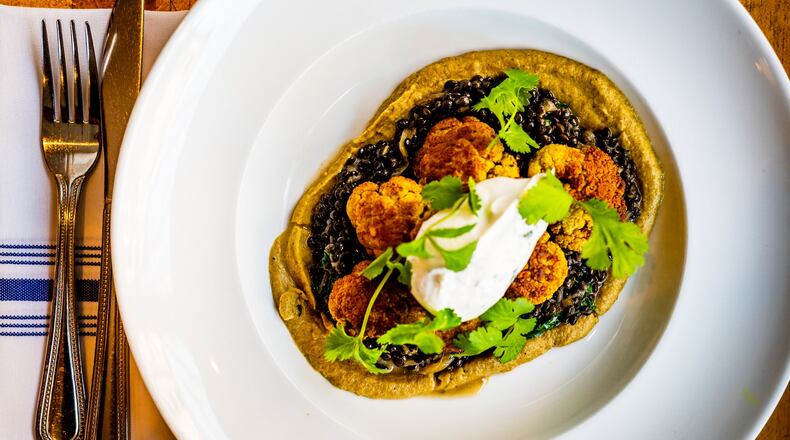 Stewed Lentils with curried cauliflower, charred eggplant puree, cilantro and yogurt sauce at the Genral Muir can serve four. CONTRIBUTED BY HENRI HOLLIS