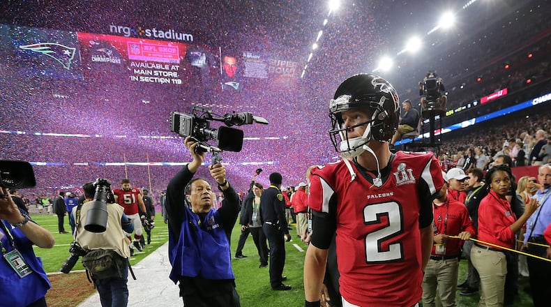 A dejected Matt Ryan walks off the field as the confetti flys falling to the Patriots 34-28 in the Super Bowl on Sunday Feb. 5, 2017, in Houston. This game is the most-watched sporting event in 2017 through July 12. Curtis Compton/ccompton@ajc.com