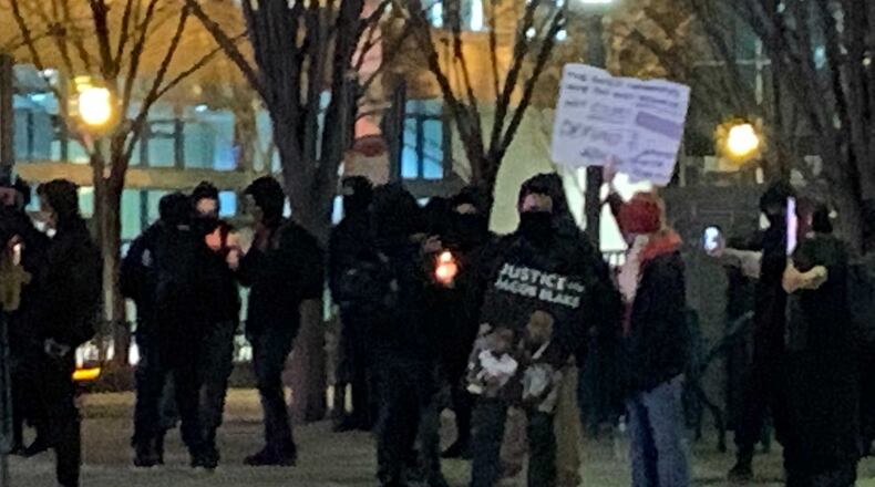 Protesters brought candles and placards to contest a Wisconsin prosecutor's decision that failed to charge Jacob Blake's shooter.
