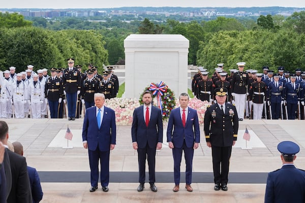 President Donald Trump, Vice President JD Vance, Secretary of Defense Pete Hegseth and Major General Trevor Bredenkamp, commanding general of the Joint Task Force-National Capital Region and the U.S. Army Military District of Washington, right, attend a Memorial Day wreath laying ceremony at Arlington National Cemetery, in Arlington, Va., Monday, May 26, 2025. (AP Photo/Jacquelyn Martin)